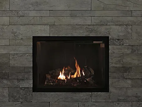 Modern gas fireplace with gray stone surround