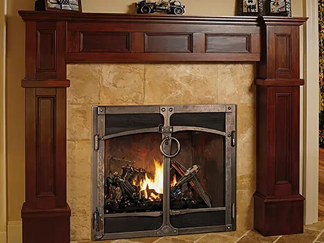 Gas fireplace with ornate mantel and stone surround