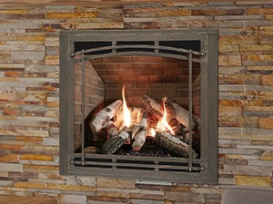 Cozy living room featuring a stone gas fireplace with a burning fire, wooden mantel, hammock chair, and comfortable seating