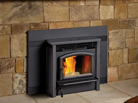 High-efficiency wood-burning stove installed in a stone fireplace.