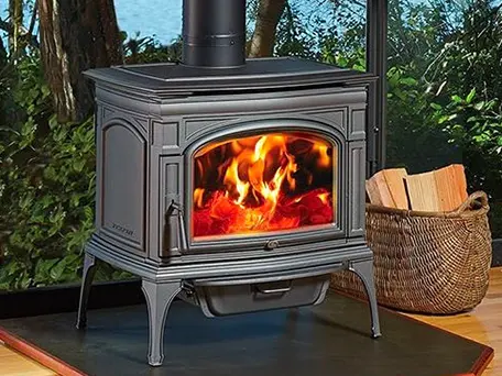 Cast iron wood-burning stove with fire burning brightly