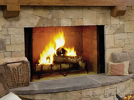 Cozy fireplace with burning logs, providing warmth and ambiance.