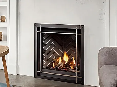 Modern gas fireplace with herringbone firebrick and bronze frame